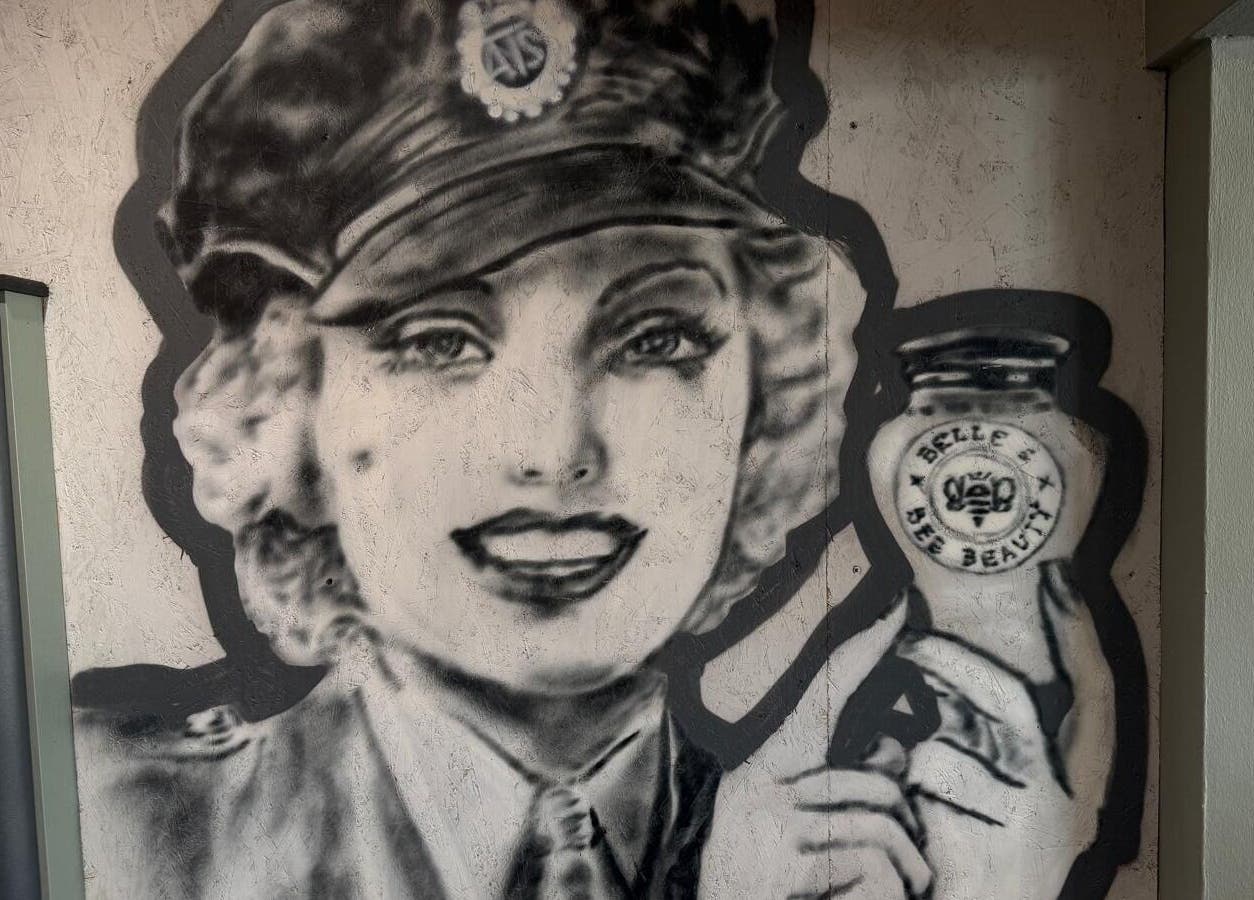 Artistic mural at Belle & Bee Beauty X Henlow, Henlow Camp, England, GB, featuring a vintage-style portrait.