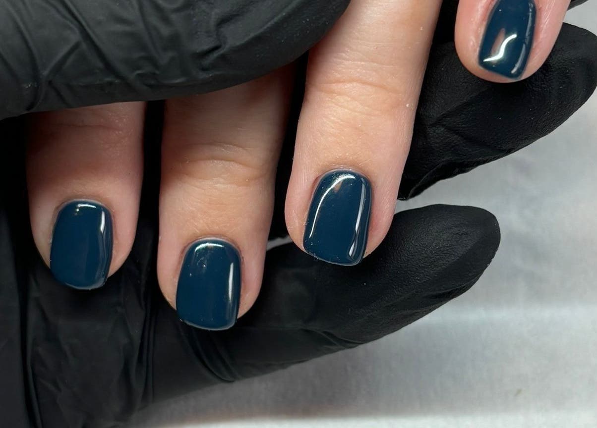 Glossy blue manicure at Belle & Bee Beauty X Henlow, Henlow Camp, England, GB. Perfect nail care.