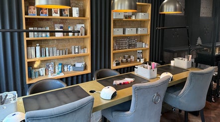 Stylish nail station at Belle and Bee Beauty, Baldock, England, GB, featuring sleek shelves with products.