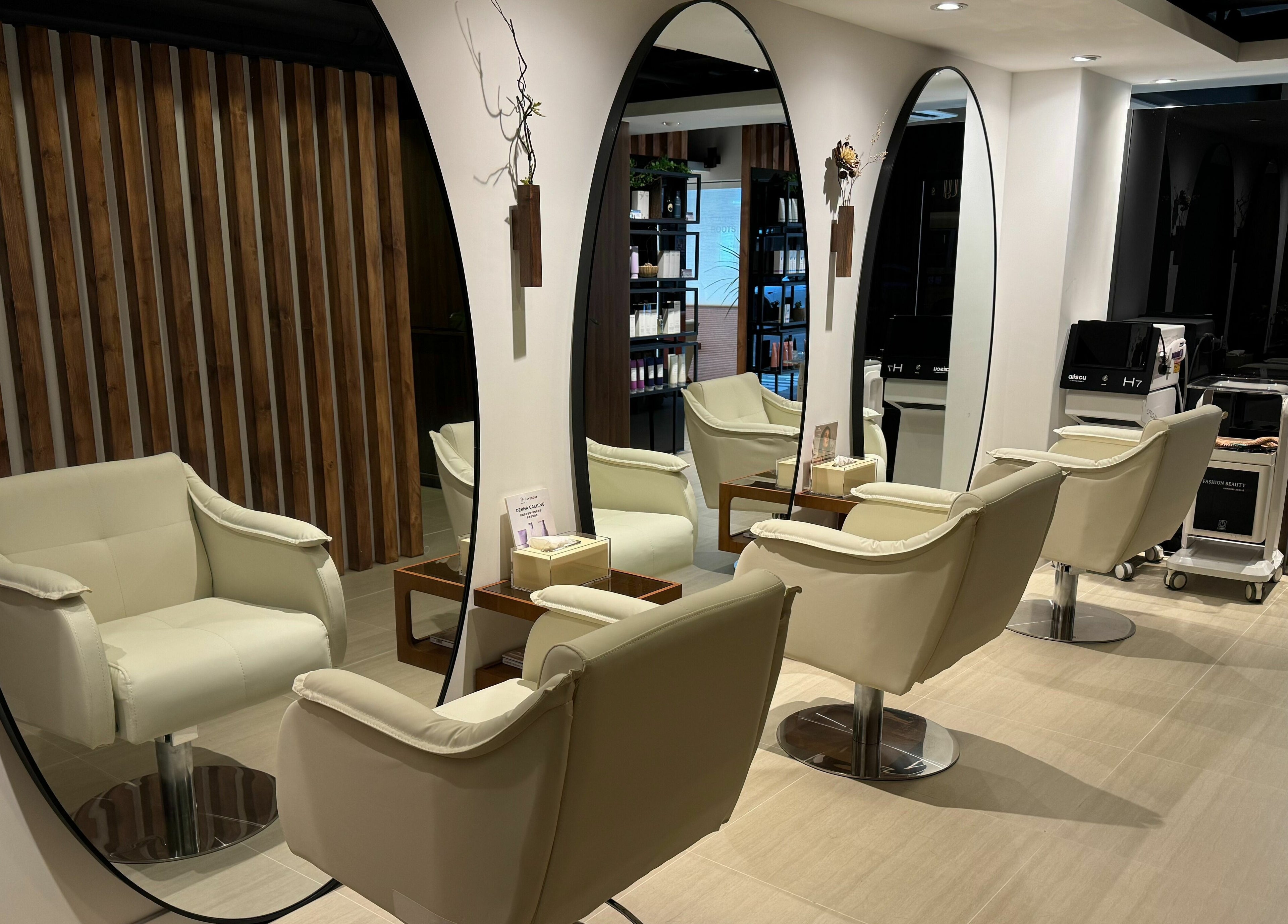 Stylish salon interior at Roots, 香港島, 香港島, HK, featuring plush chairs and elegant mirrors.