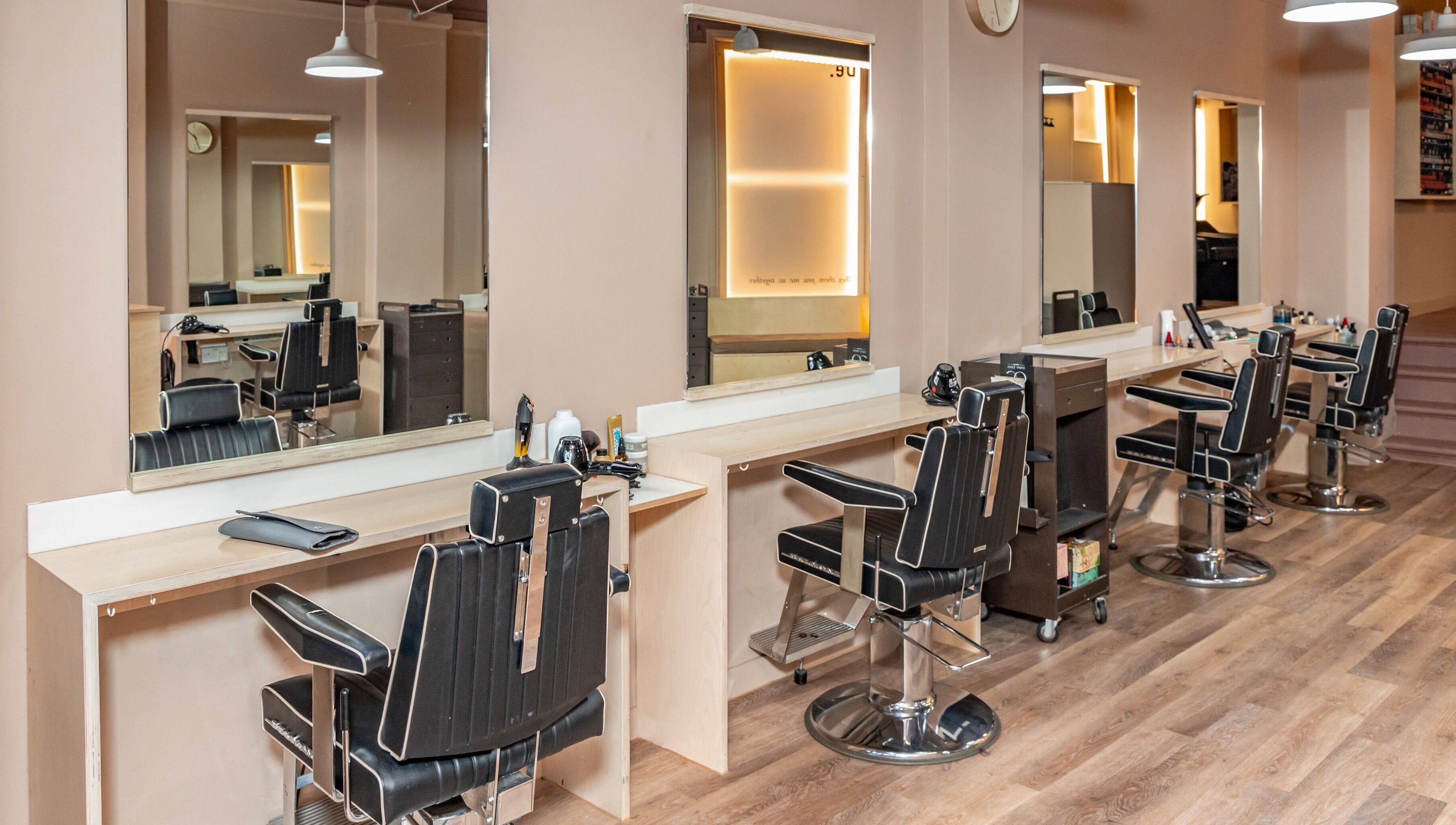 Modern salon chairs at De Salons Brixton in London, England, GB, showcasing sleek interior design.