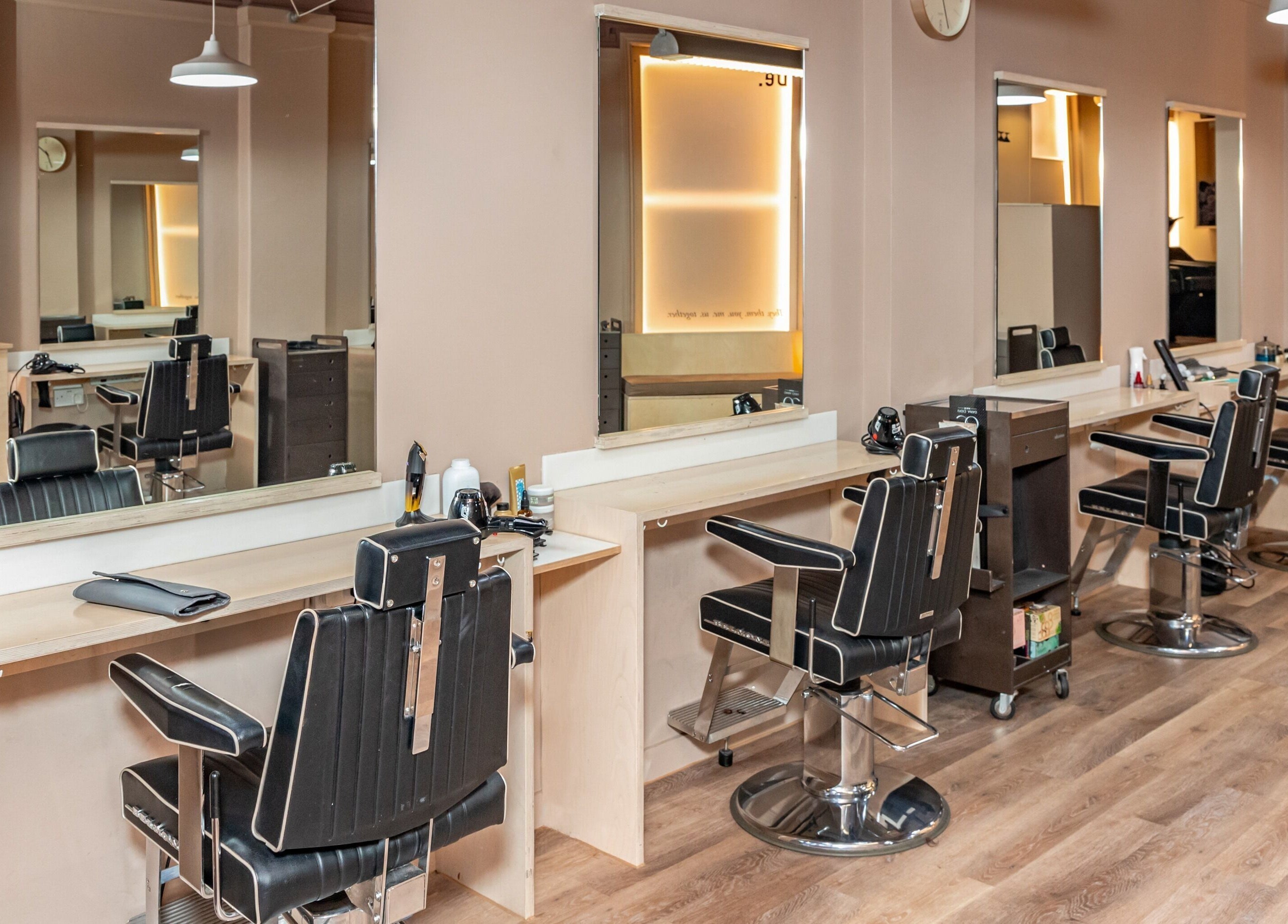 Modern salon chairs at De Salons Brixton in London, England, GB, showcasing sleek interior design.