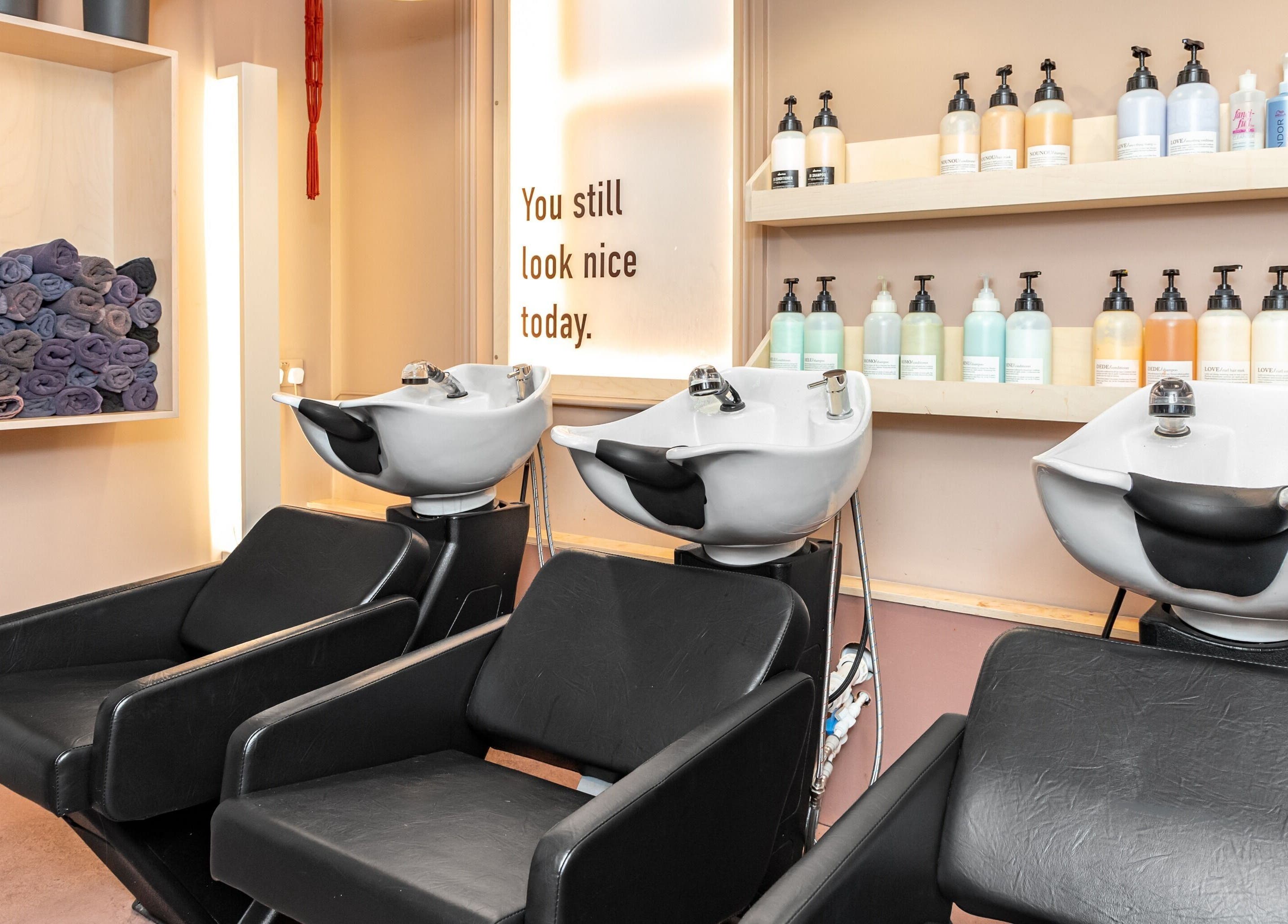 Elegant shampoo station at De Salons Brixton, London, England, GB showcasing premium hair care products.