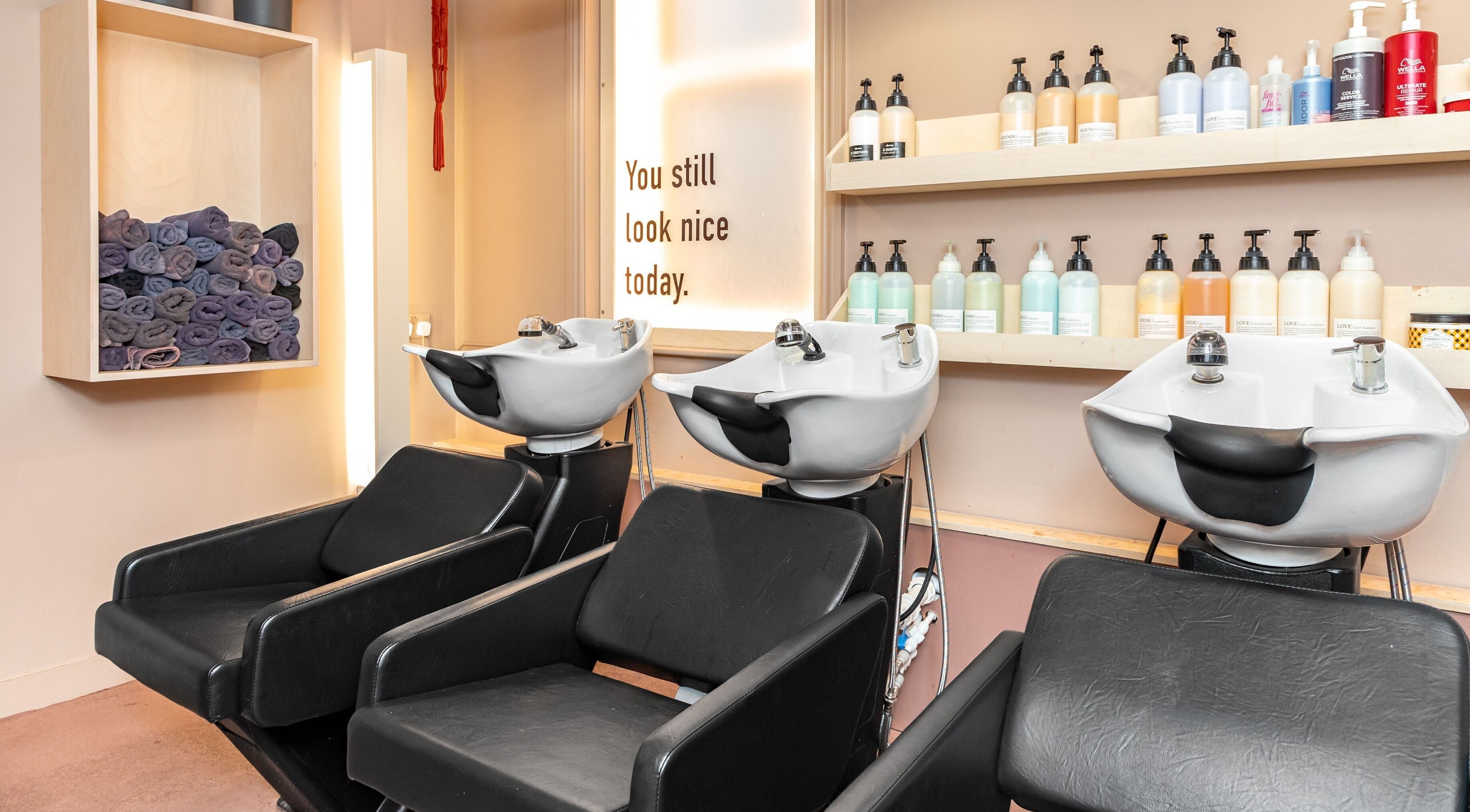 Elegant shampoo station at De Salons Brixton, London, England, GB showcasing premium hair care products.