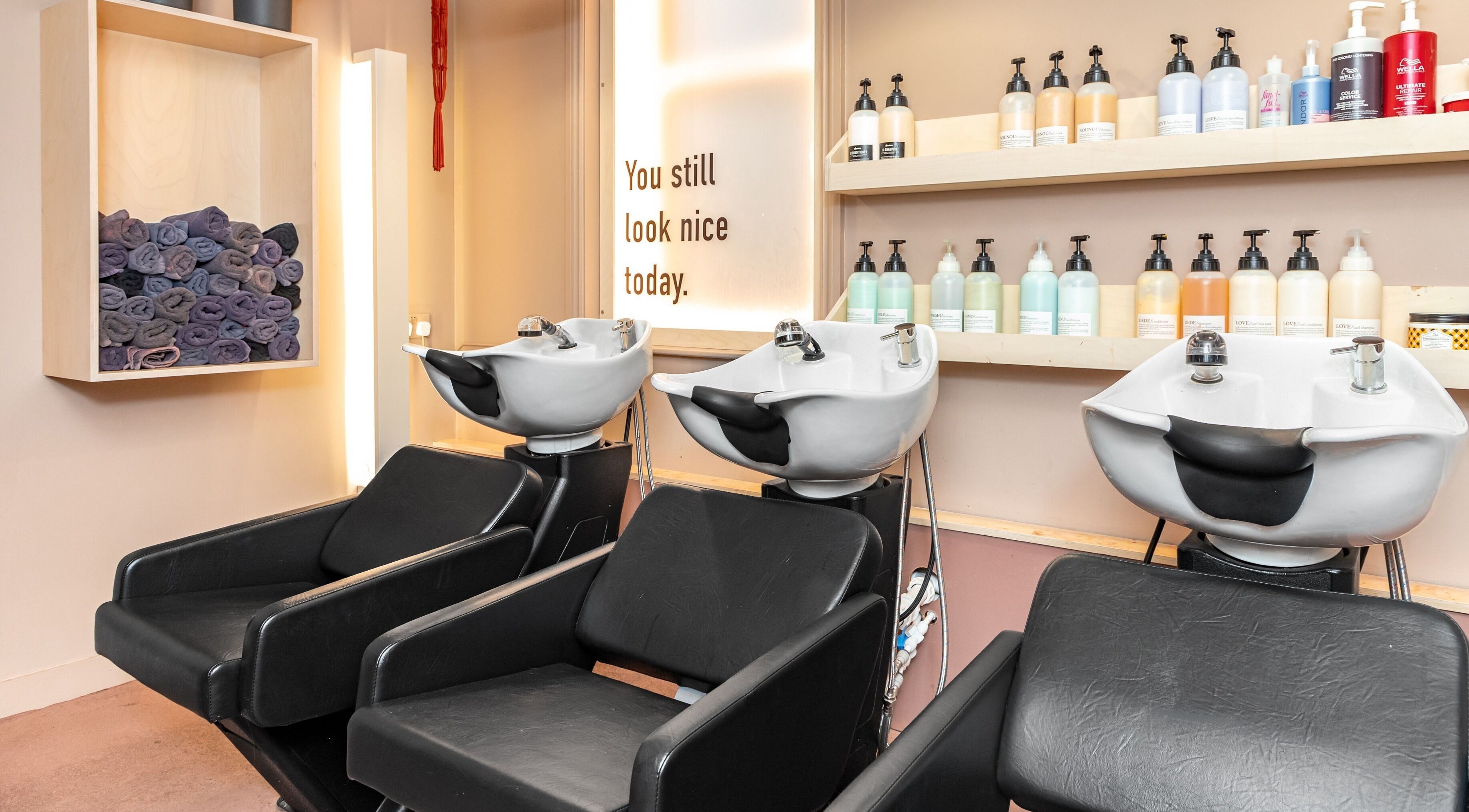 Elegant shampoo station at De Salons Brixton, London, England, GB showcasing premium hair care products.