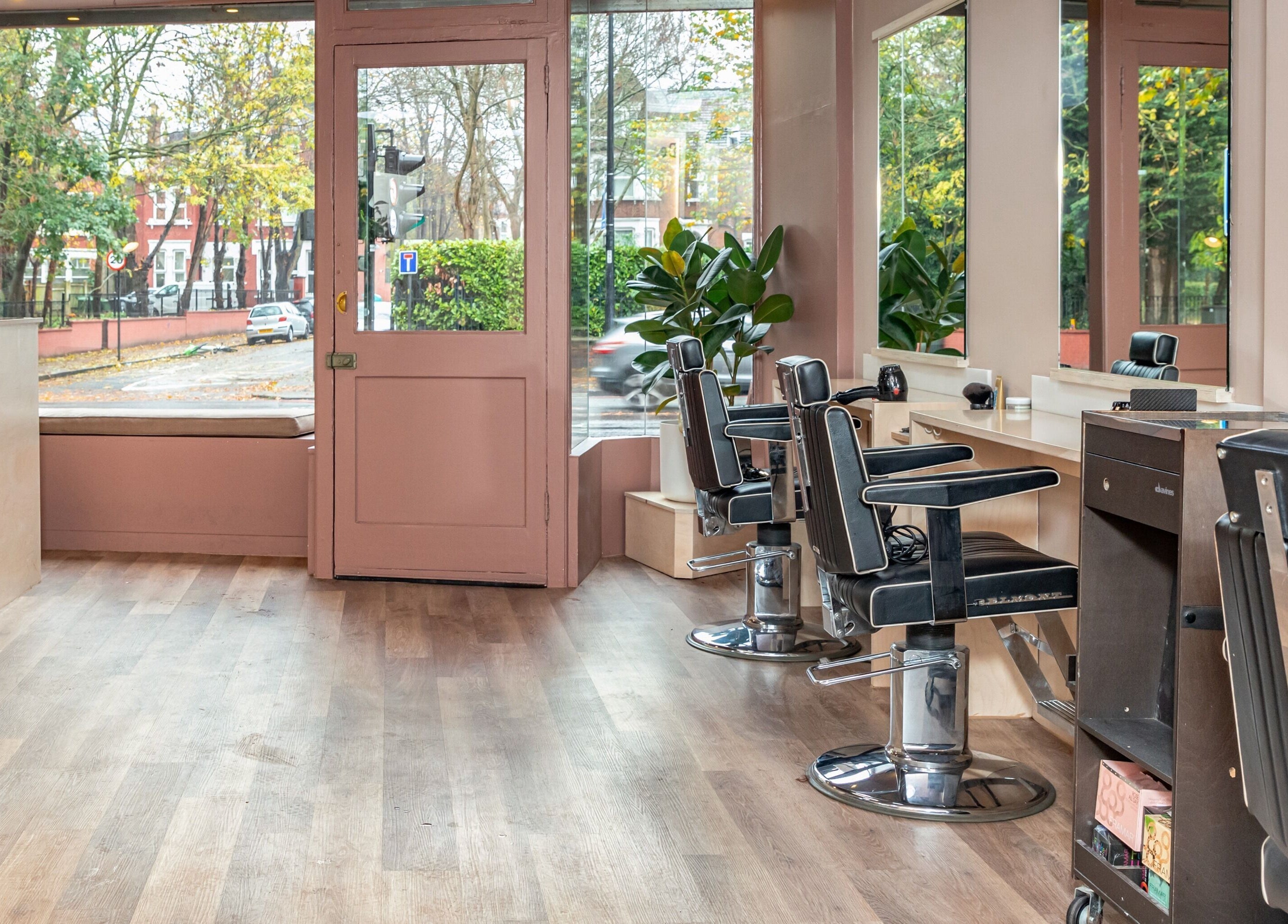 Modern interior of De Salons Brixton in London, England, GB featuring stylish chairs and large windows.