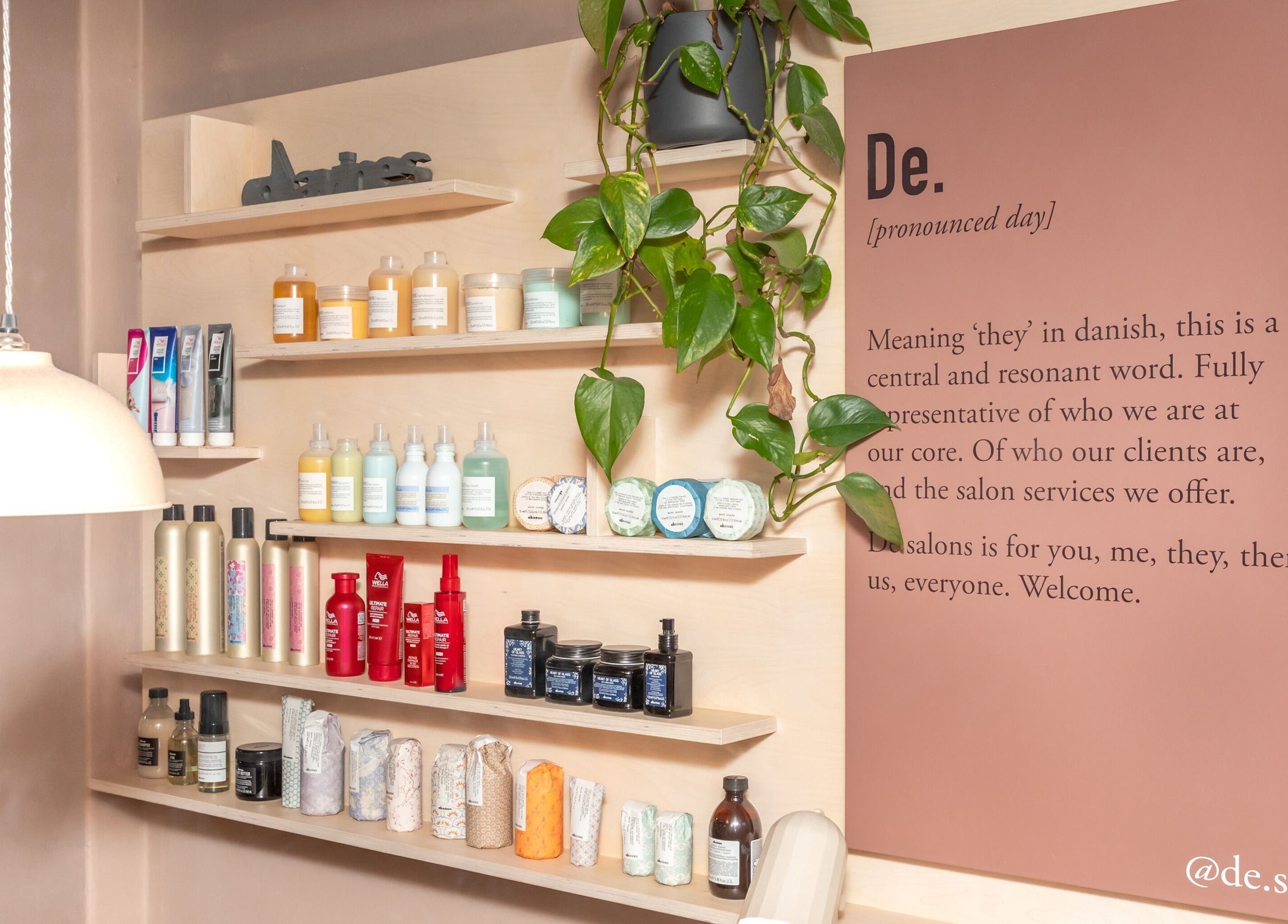 De Salons Brixton showcases shelves with beauty products and greenery in London, England, GB.