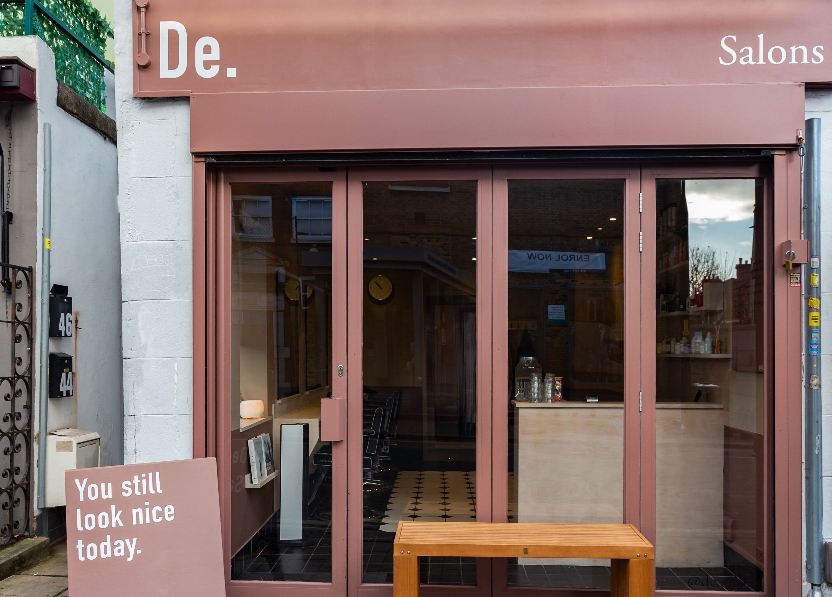 De.Salons Peckham exterior with welcoming entrance in London, England, GB, highlighting unique signage.