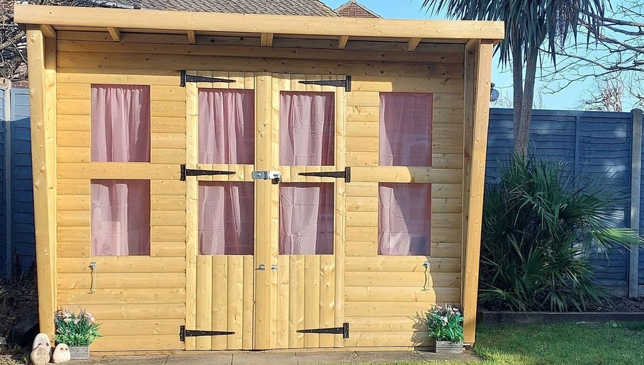Wooden cabin with pink curtains, a serene addition at AllAboutNailz, Stubbington, United Kingdom, GB.