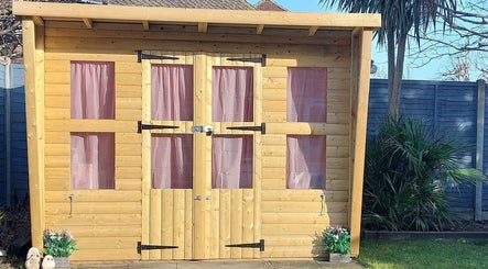 Wooden cabin with pink curtains, a serene addition at AllAboutNailz, Stubbington, United Kingdom, GB.