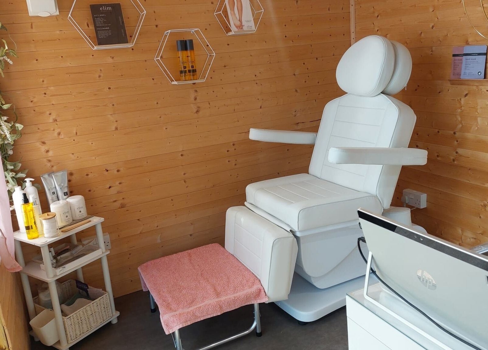 AllAboutNailz cozy treatment room, Stubbington, United Kingdom, GB, featuring a plush white chair and wooden decor.