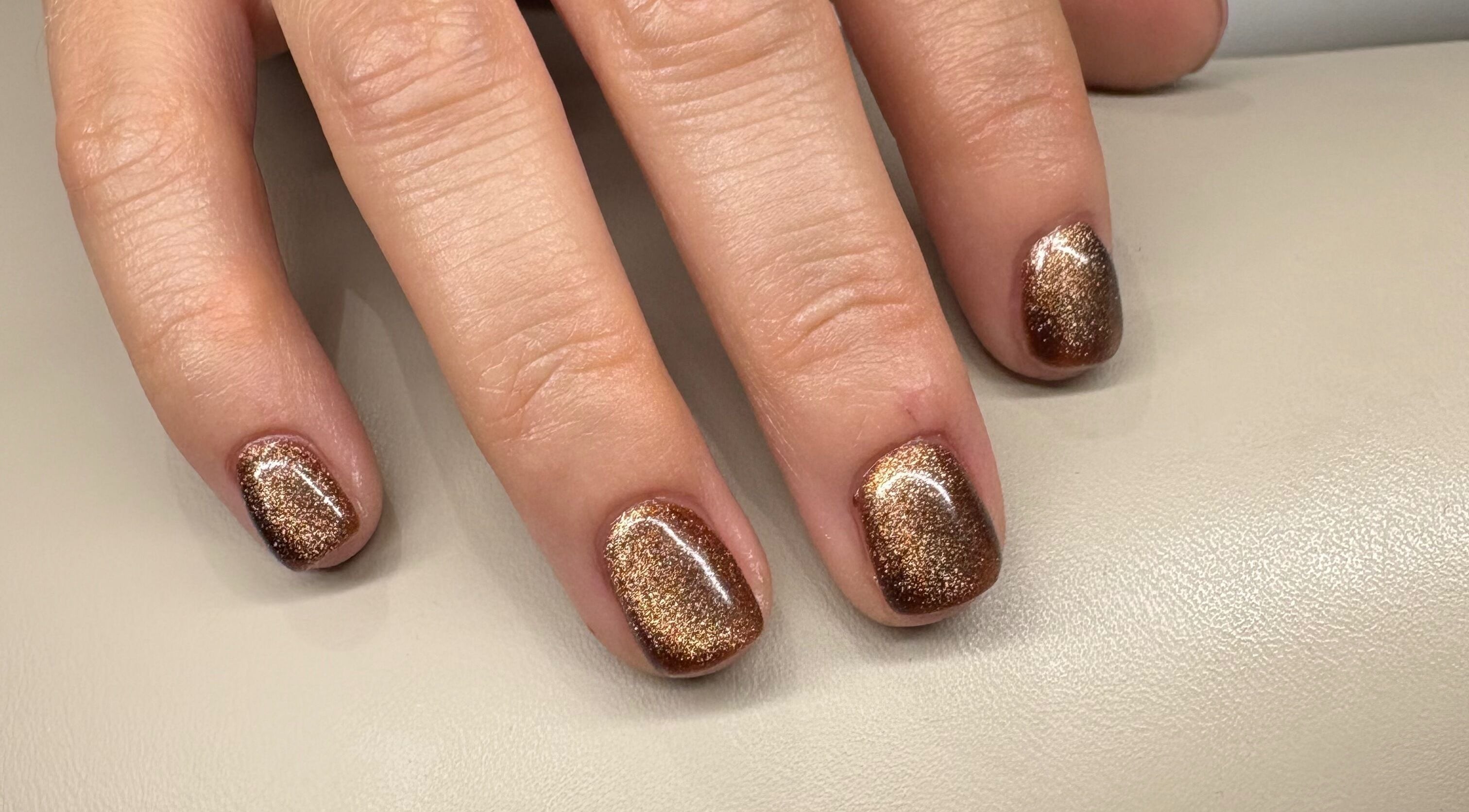 Bronze glitter nails by VE Nail Artist at Langdon Hills, England, GB, showcasing elegant shimmer.
