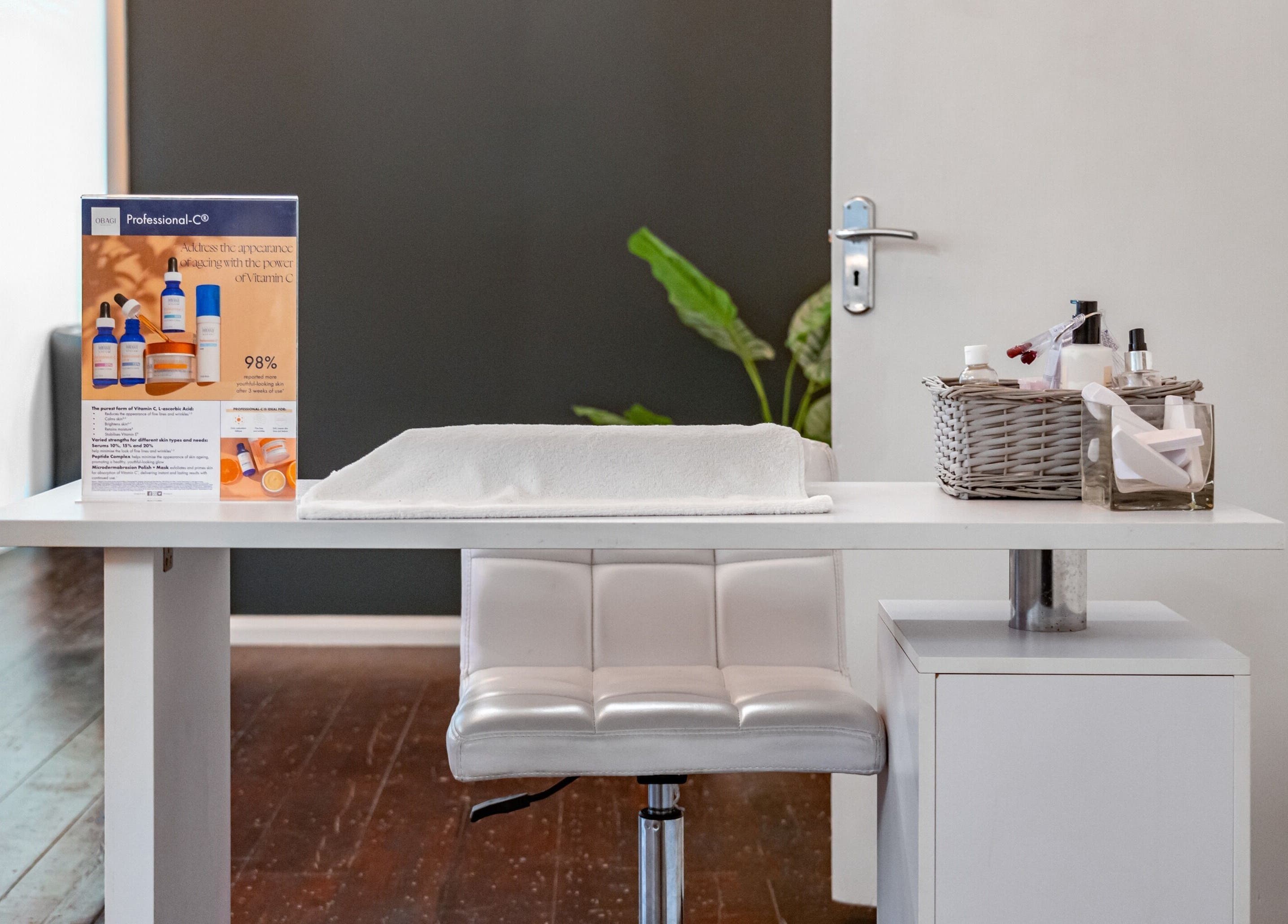 Modern treatment area at Pixel Perfect Clinic, Southampton, England, GB, showcasing beauty products and cozy seating.