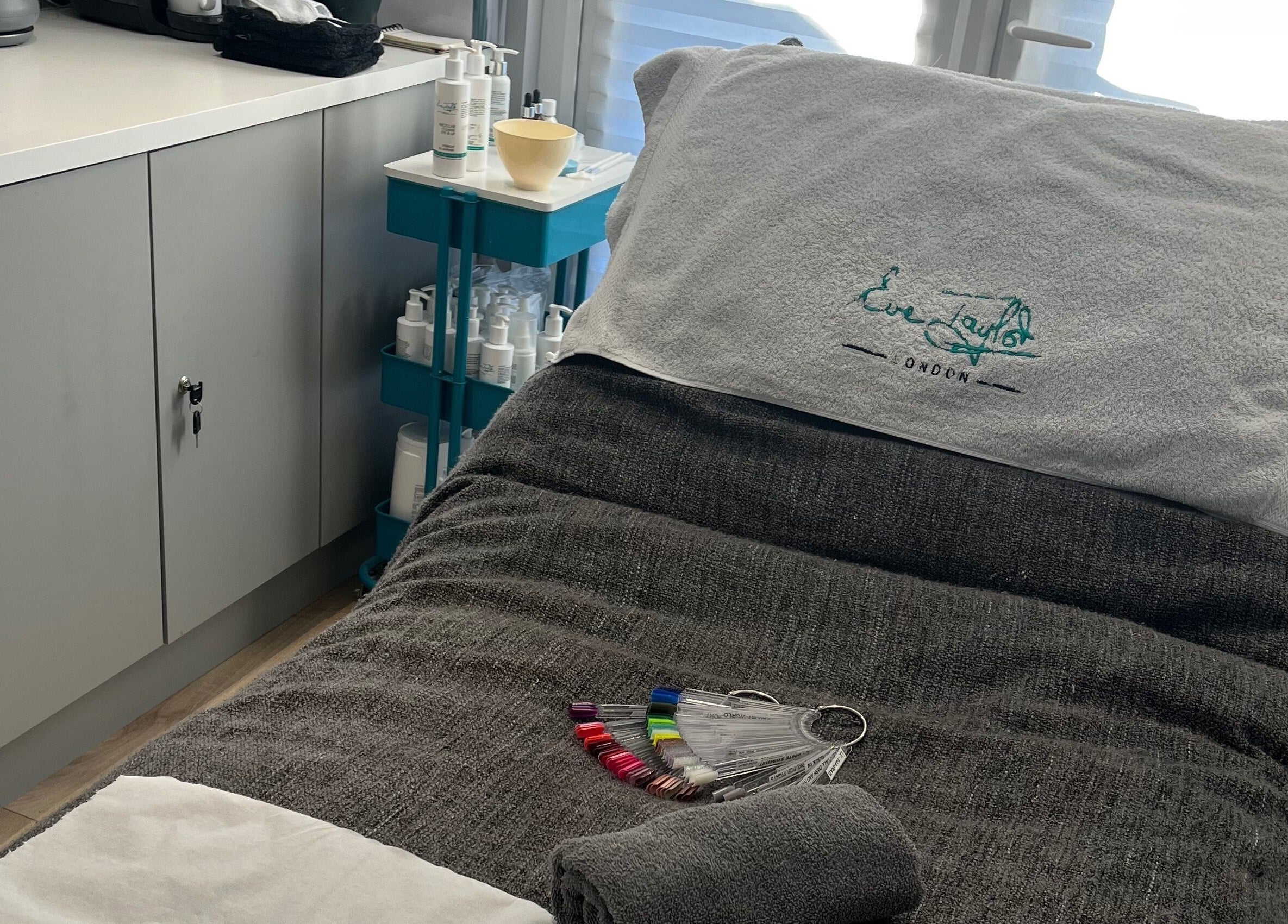 Cozy treatment bed at Glamour and Glitter by Stef, Portchester, England, GB, with soothing decor and products.