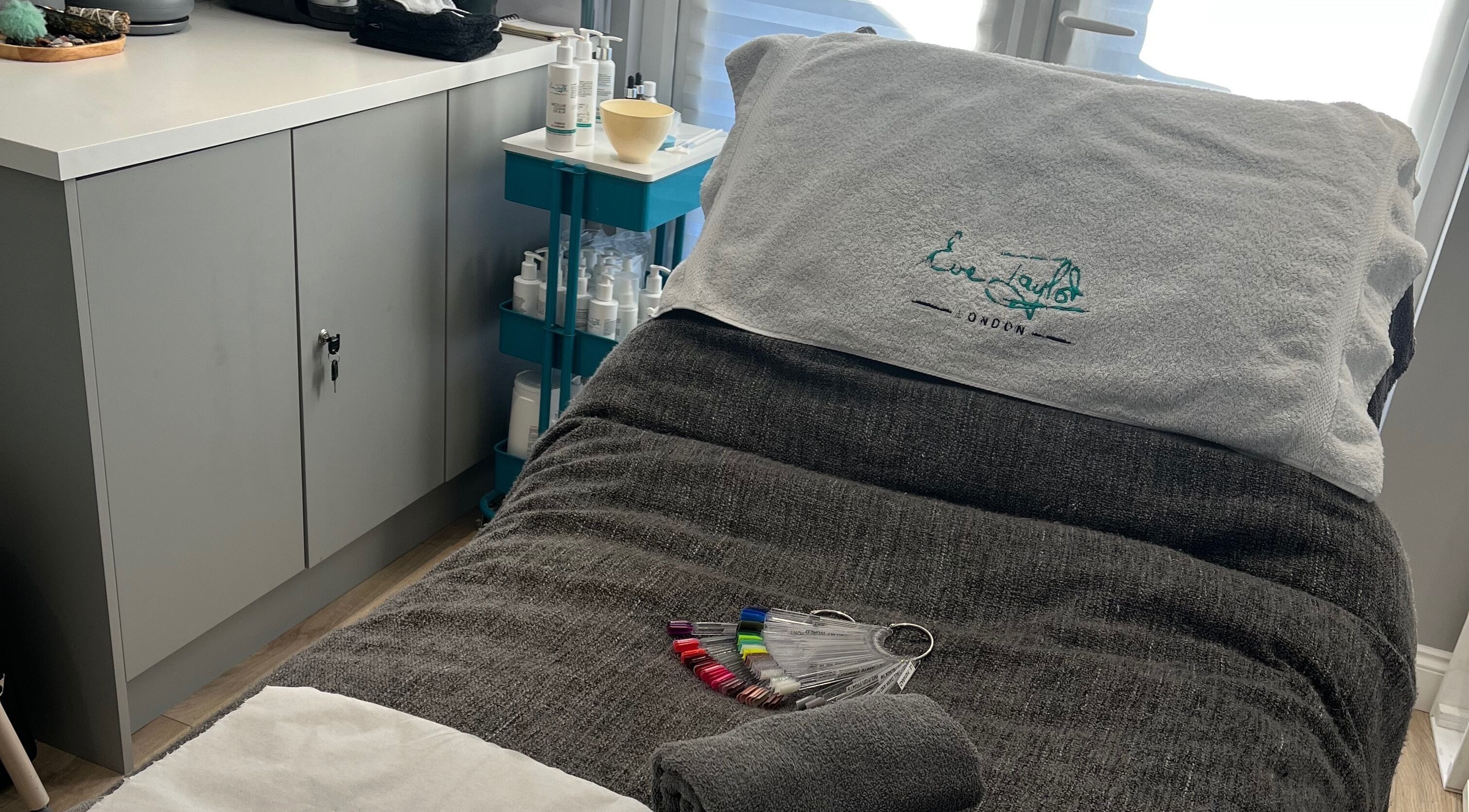 Cozy treatment bed at Glamour and Glitter by Stef, Portchester, England, GB, with soothing decor and products.