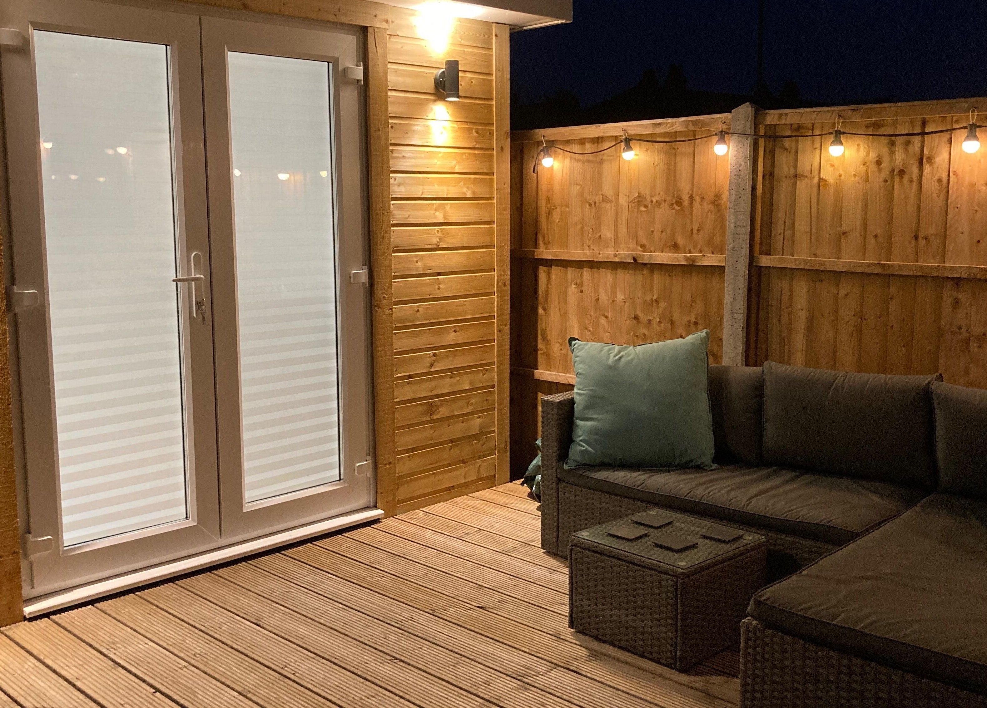 Cozy outdoor patio at Glamour and Glitter by Stef, Portchester, England, GB with elegant lighting.