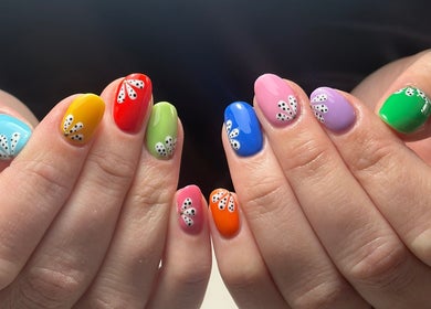 Colorful nail art with designs at Roots Hair & Co, Needham Market, England, GB.