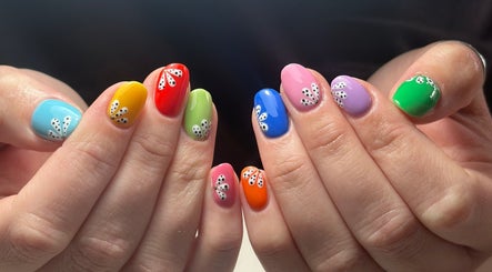 Colorful nail art with designs at Roots Hair & Co, Needham Market, England, GB.