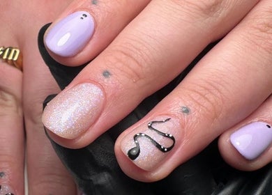 Stylish nail art featuring lilac and glitter designs at Roots Hair & Co, Needham Market, England, GB.