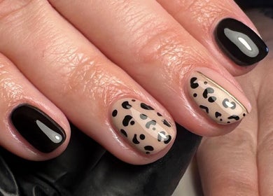 Stylish nail art with leopard design at Roots Hair & Co, Needham Market, England, GB.