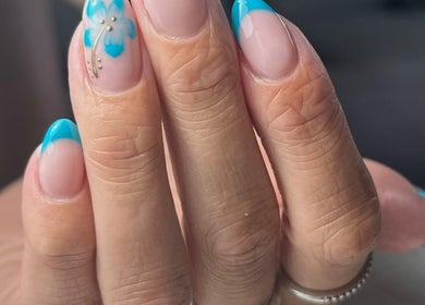 Vibrant blue floral nail art at Roots Hair & Co, Needham Market, England, GB.