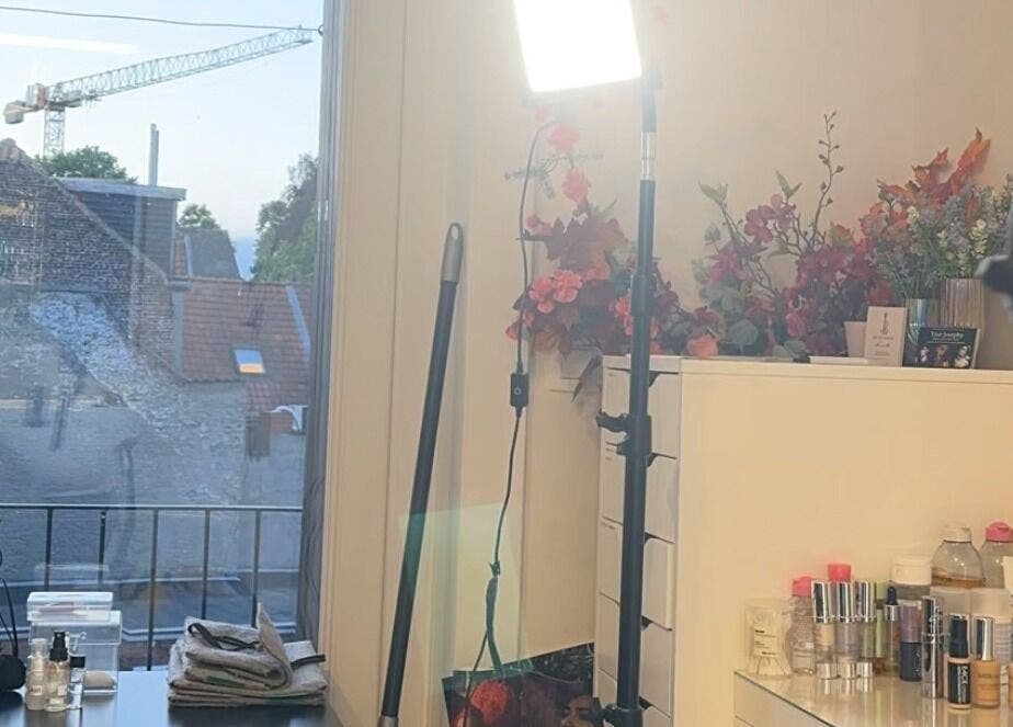 Studio Tinka by Tine Josephy in Gent, Vlaams Gewest, BE. Makeup setup with bright lighting and floral decor.
