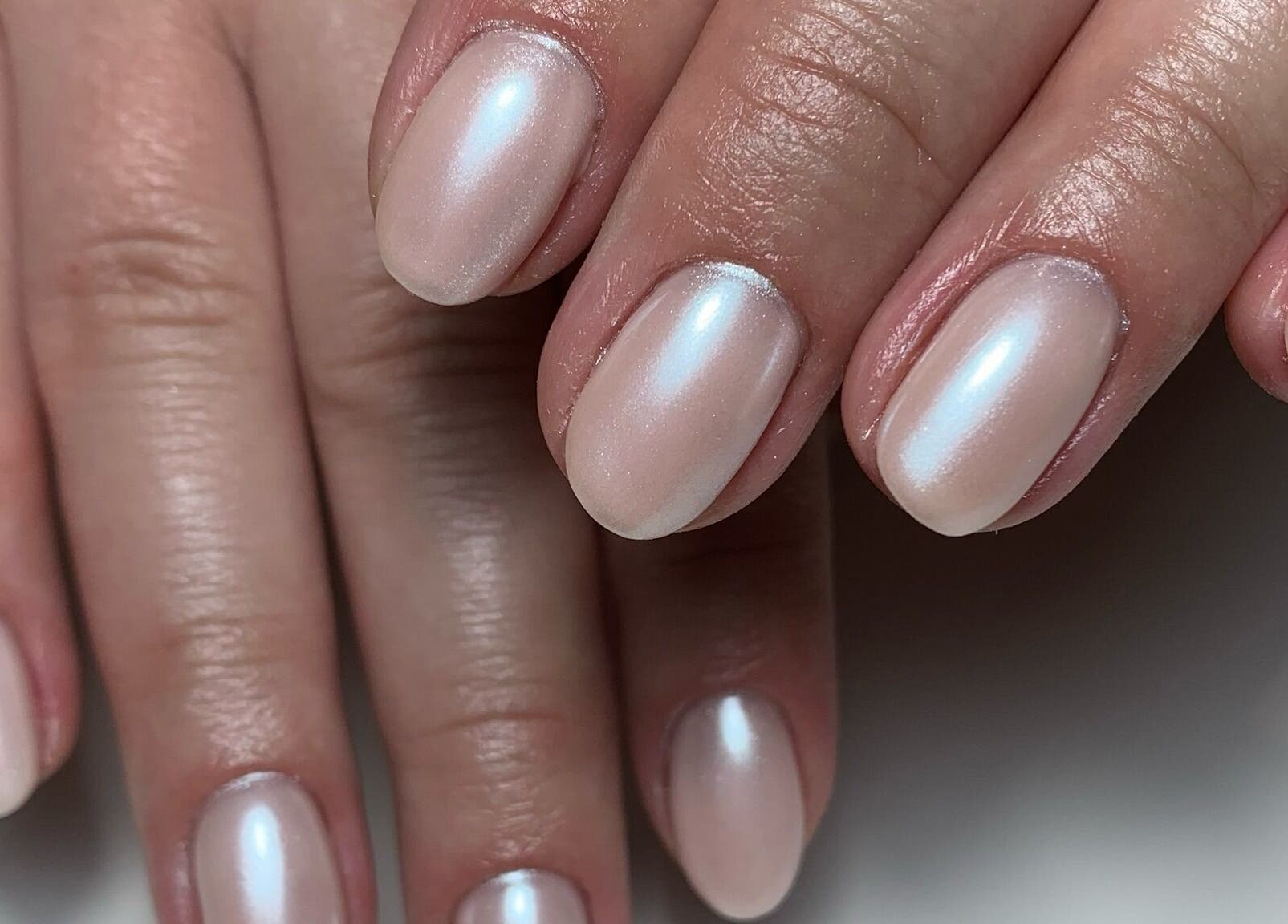 Elegant pearl manicure at By Chantelle Studio 94, Livingston, Scotland, GB, showcasing soft, glossy finish.