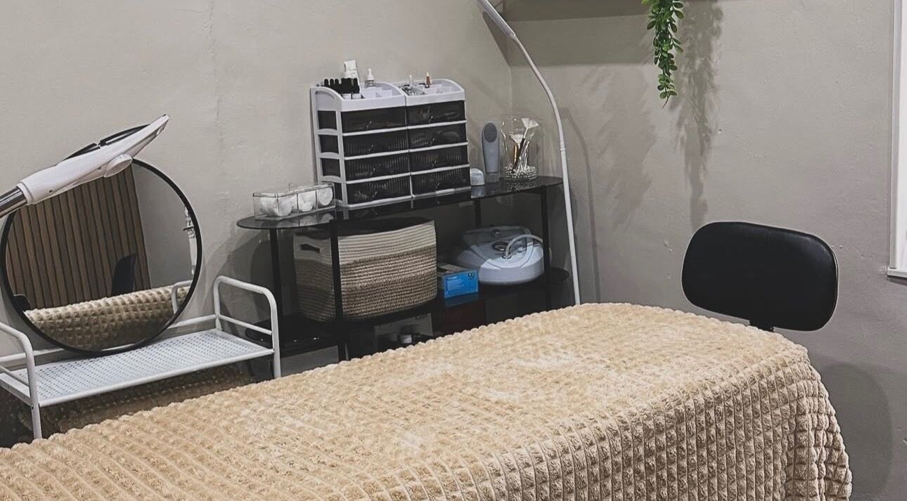 Tranquil treatment room at Queens Beauty, Mansfield, England, GB, features cozy bed and stylish decor.