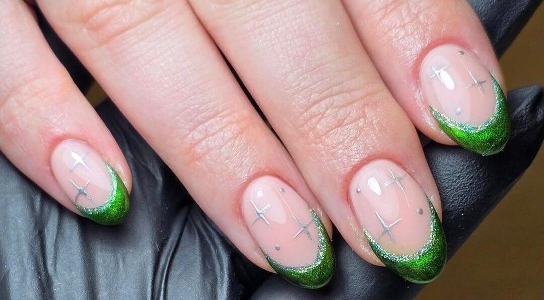 Green nail art with silver stars at Bare Beauty, Crawley, England, GB.