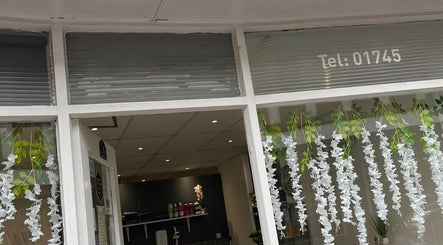 Kalis Aesthetics entrance adorned with white floral decor in Rhyl, Wales, GB.