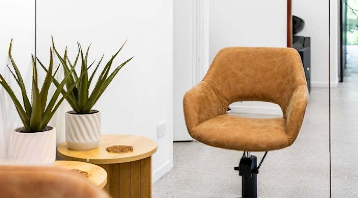 Stylish salon chair and potted plants at Edge Hairdressing, Tamborine Mountain, QLD, AU.