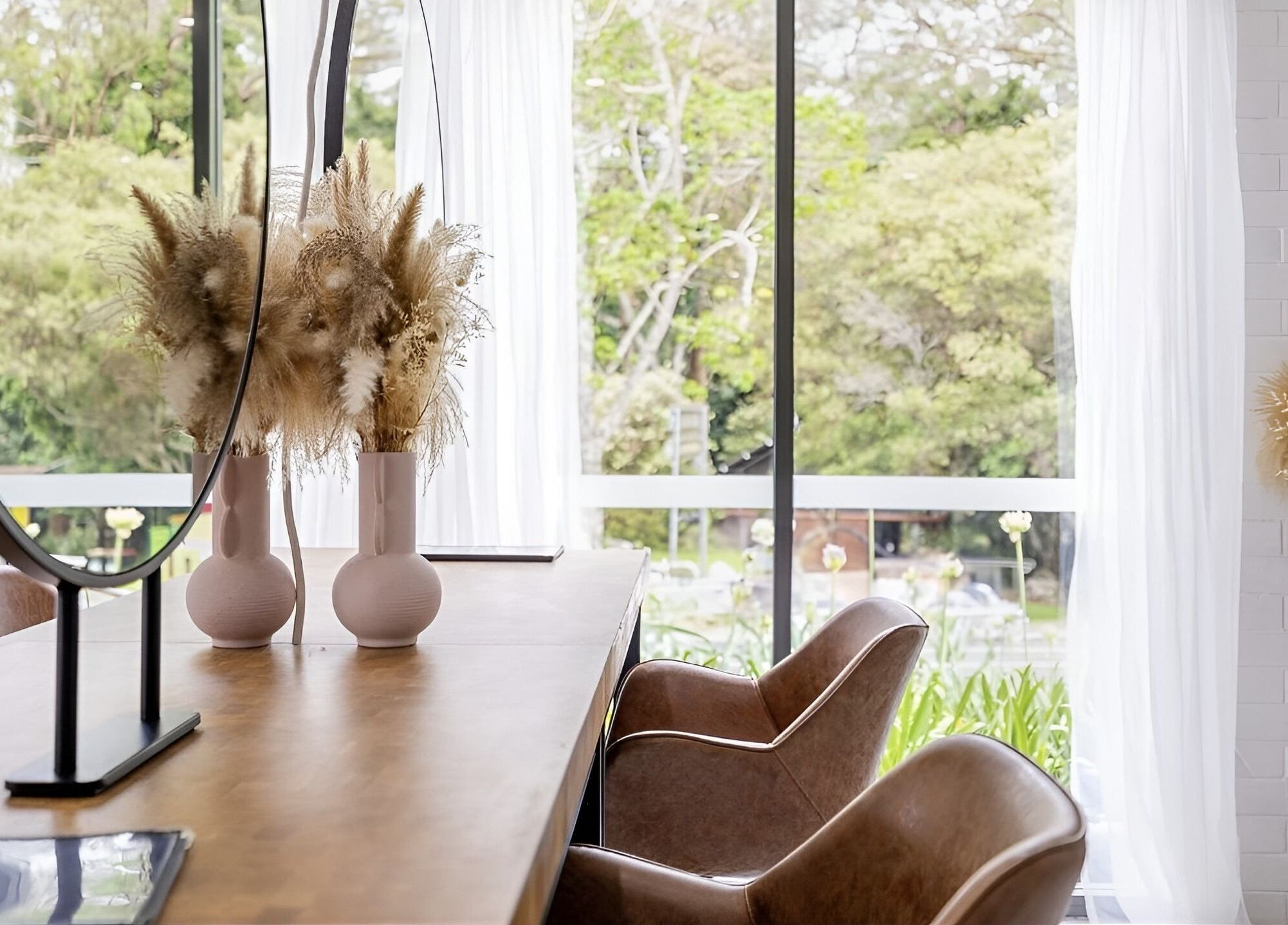 Bright, elegant interior of Edge Hairdressing at Tamborine Mountain, QLD with chic decor and lush greenery outside.
