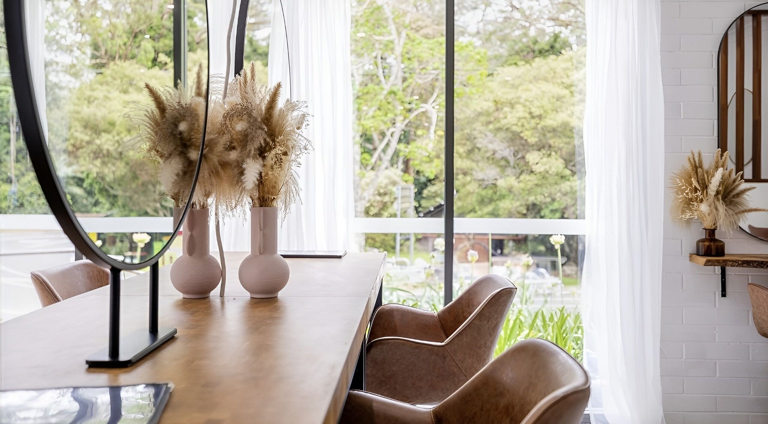 Bright, elegant interior of Edge Hairdressing at Tamborine Mountain, QLD with chic decor and lush greenery outside.