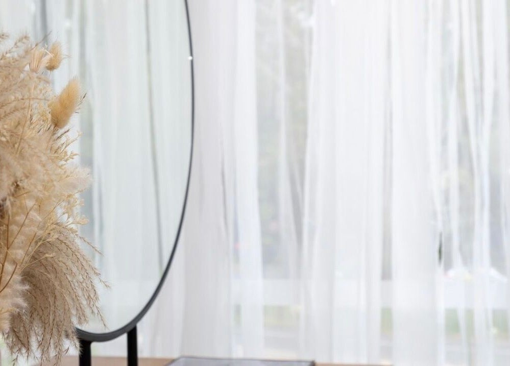 Elegant decor with dried plants and circular mirror at Edge Hairdressing, Tamborine Mountain, QLD, AU.