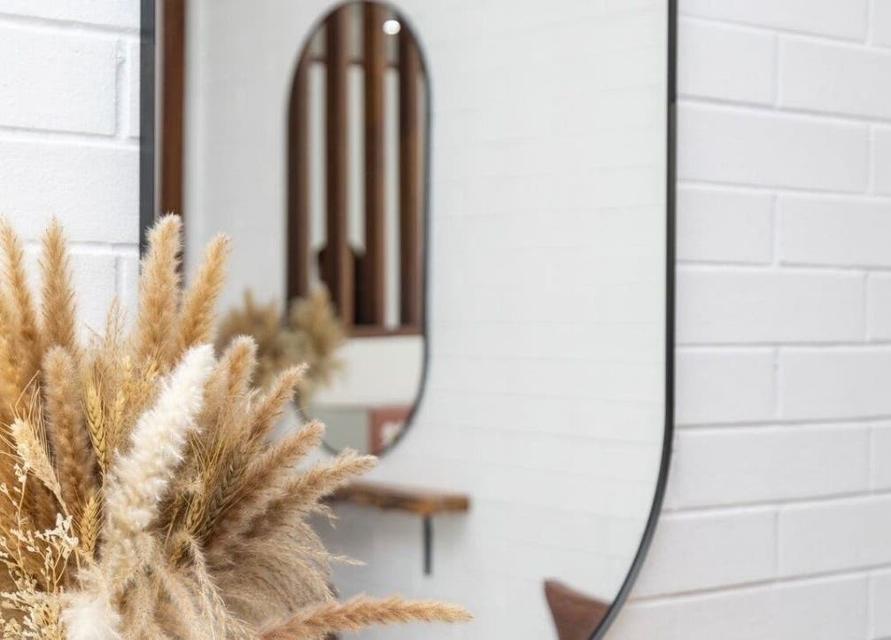 Elegant interior decor at Edge Hairdressing in Tamborine Mountain, QLD, AU with a stylish mirror and pampas grass.