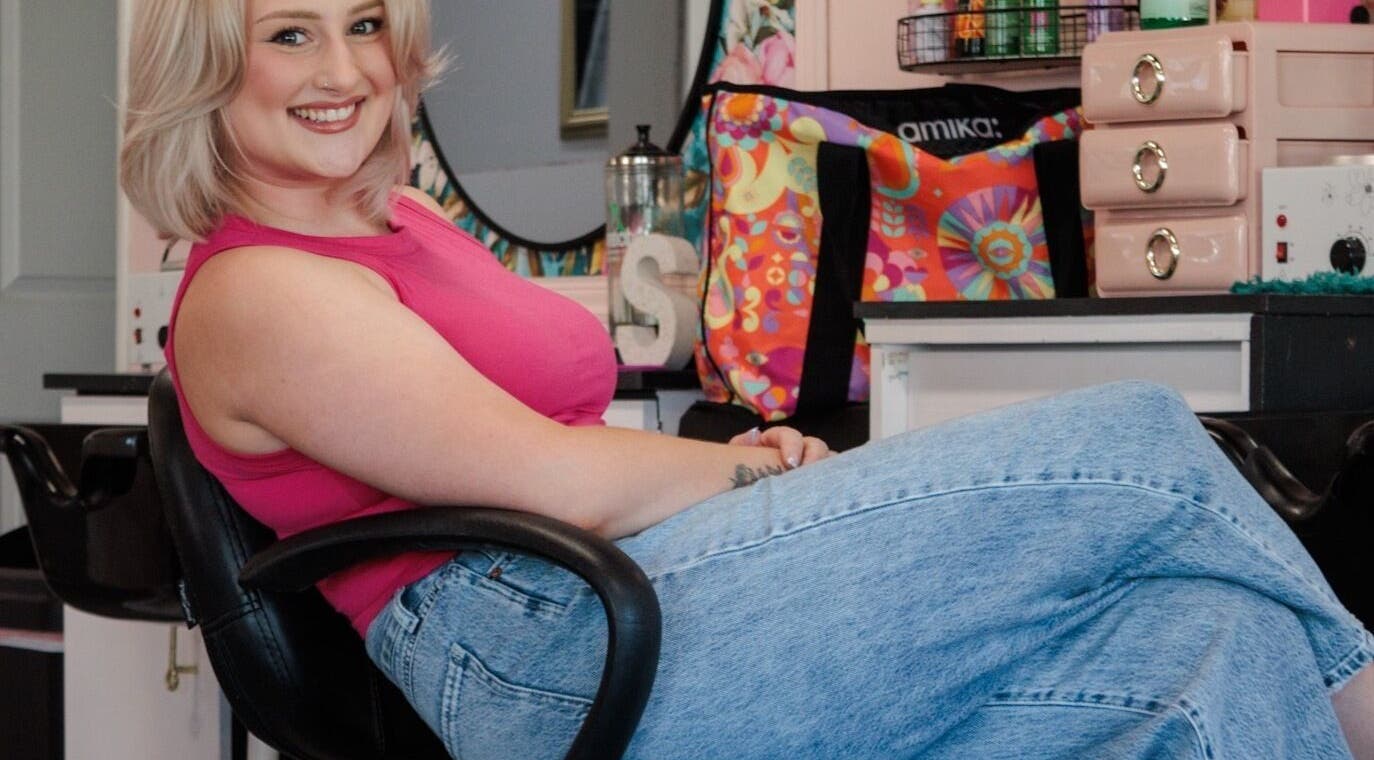 Smiling person in casual attire at Isabella Bennett, Ottumwa, Iowa, US beauty salon.
