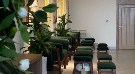 Elegant seating at The Unique White Salon, Riyadh, Riyadh Province, SA, with lush green plants.