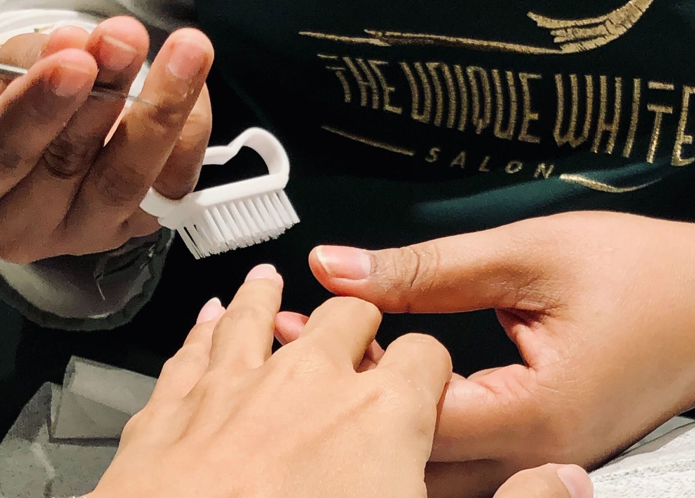 Manicure service at The Unique White Salon in Riyadh, Riyadh Province, SA, showcasing detailed nail grooming.