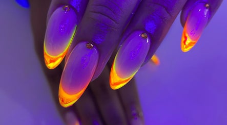 Vibrant neon nails from Sculpted in Cape Town, Western Cape, ZA, showcasing artistic beauty under glowing light.