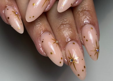 Elegant nail art with golden star designs at Sculpted in Cape Town, Western Cape, ZA.