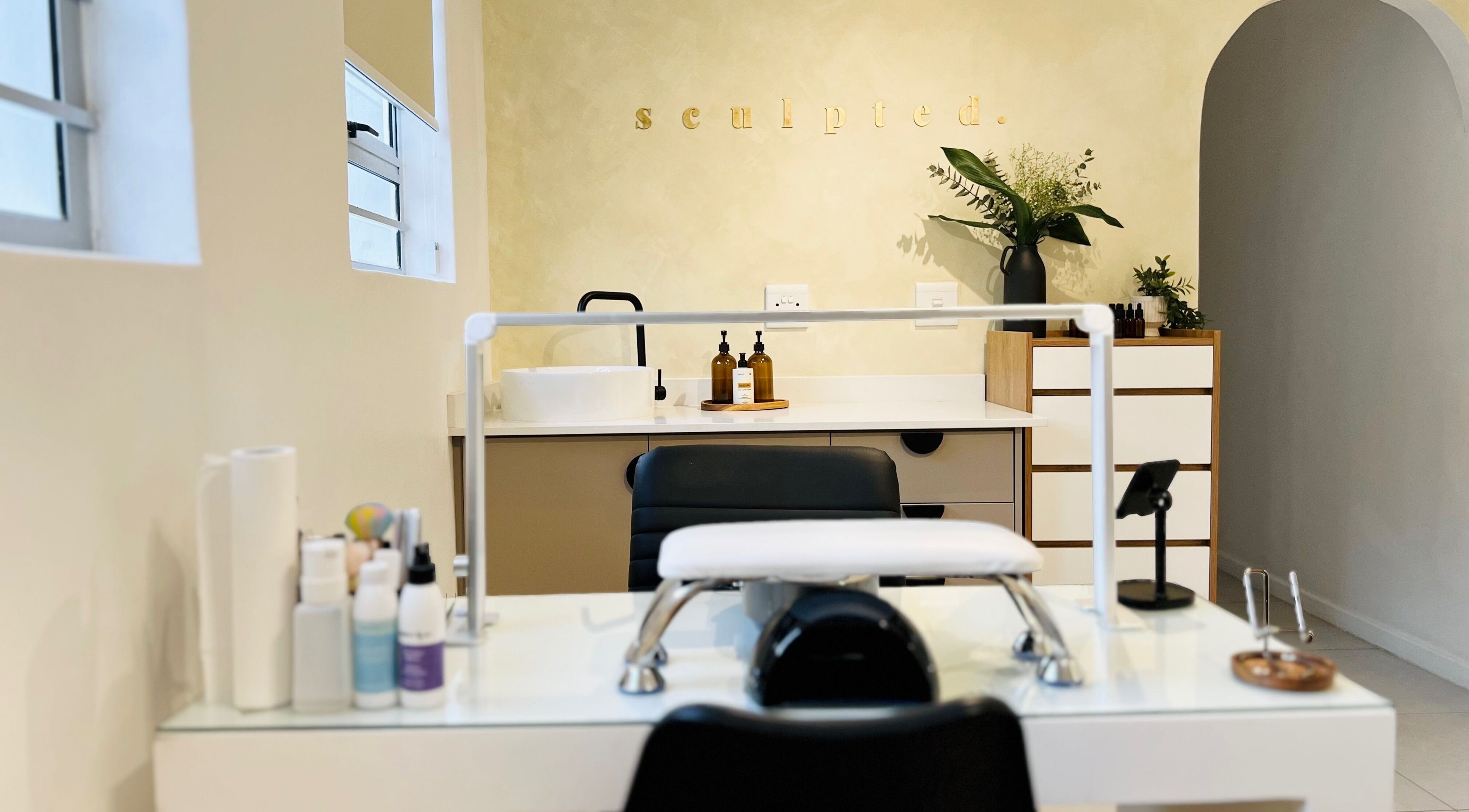 Modern beauty treatment room at Sculpted in Cape Town, Western Cape, ZA, featuring a manicured setup.