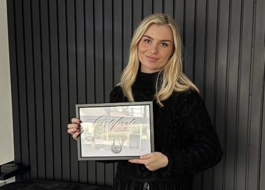 Professional holding certificate at The Nail&Brow Room, newtonmore, Highland, GB.