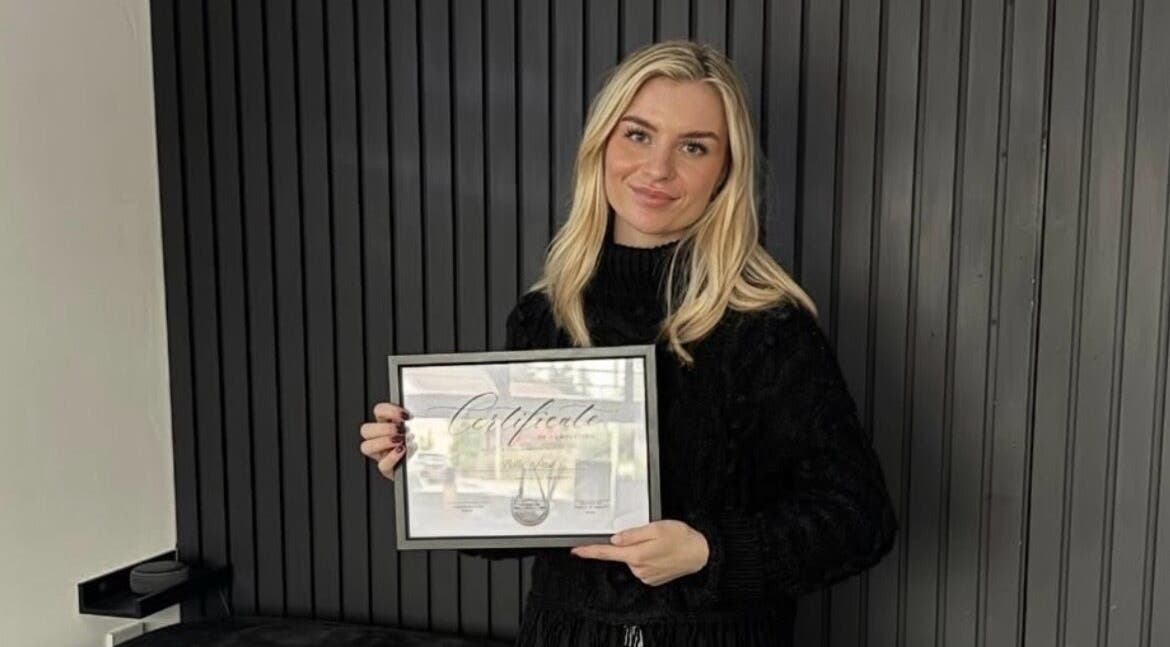 Professional holding certificate at The Nail&Brow Room, newtonmore, Highland, GB.