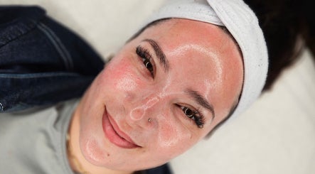 A woman enjoys a rejuvenating facial at Hexie Beauty in Manchester, England, GB, showcasing clear, glowing skin.