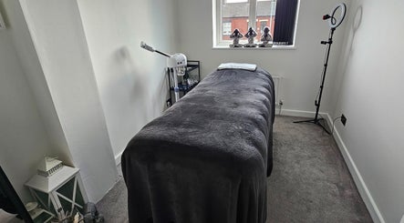 Relaxation room at Hexie Beauty, Manchester, England, GB with massage bed and spa decor.