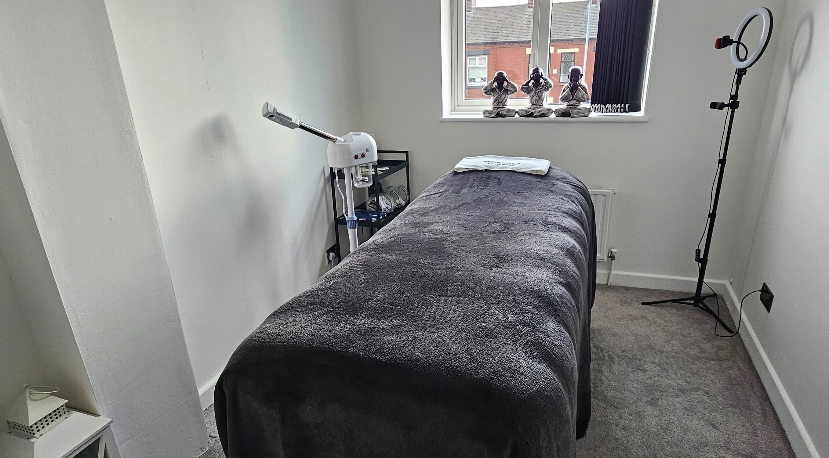Relaxing treatment room at Hexie Beauty, Manchester, England, GB, featuring comfortable bed and ambient lighting.