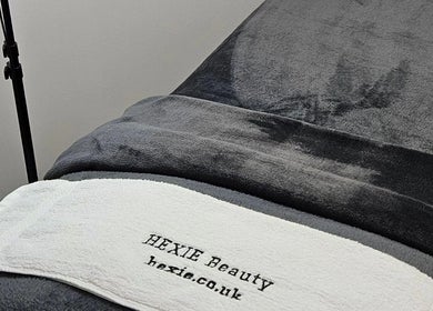 Close-up of a treatment bed at Hexie Beauty in Manchester, England, GB, showcasing comfort and style.