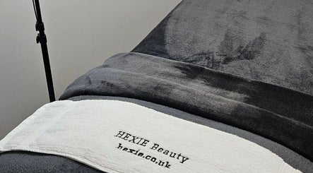 Close-up of a treatment bed at Hexie Beauty in Manchester, England, GB, showcasing comfort and style.
