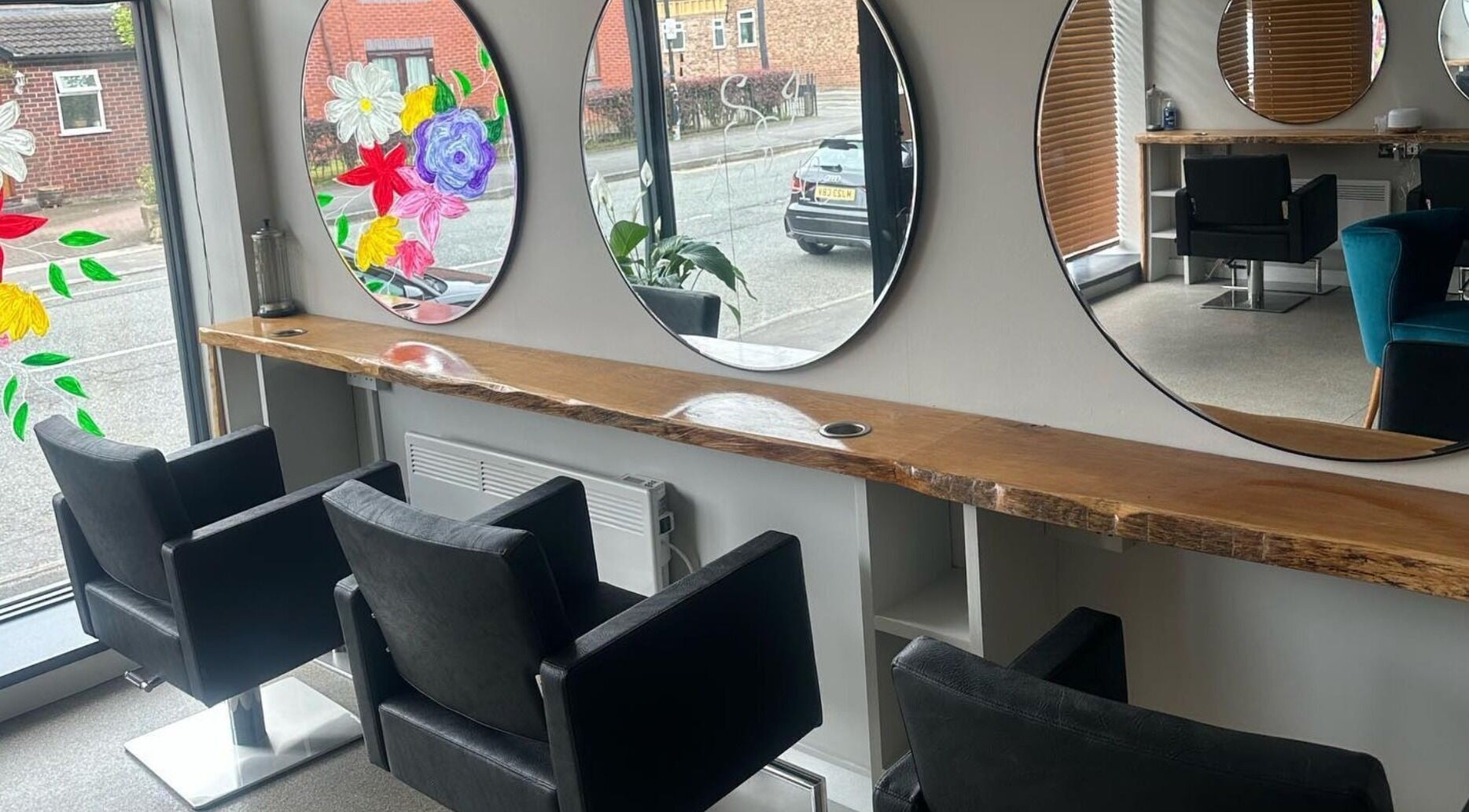 Contemporary salon interior SJ Salon, Sale, England, GB with chic mirrors and stylish black chairs.