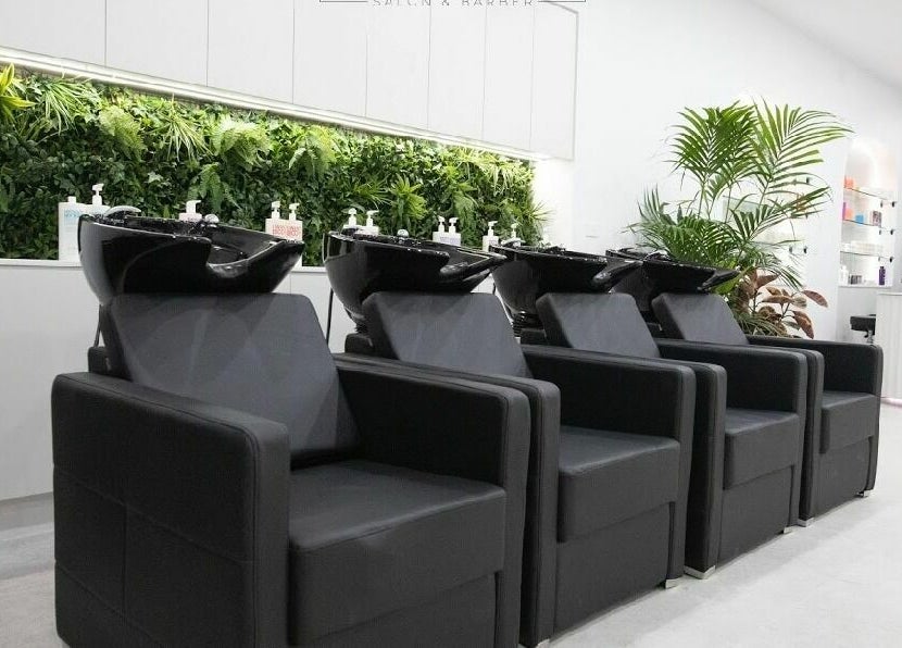 Luxurious wash stations at Maliha Salon And Barber, Melbourne, Victoria, AU, with a lush plant backdrop.